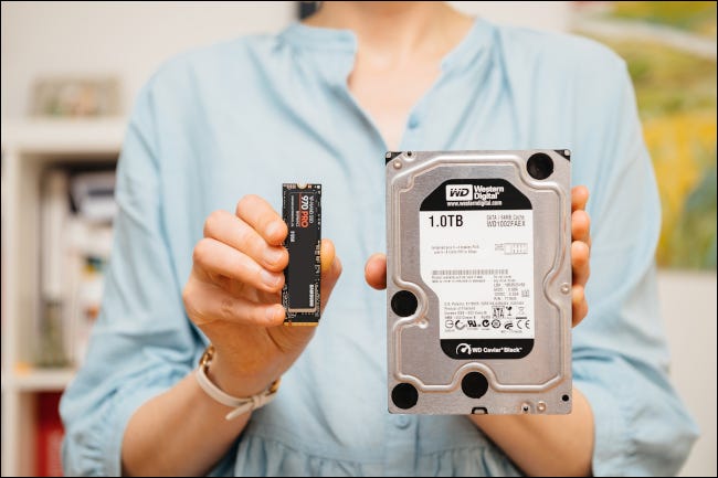 woman holding nvme hdd drives